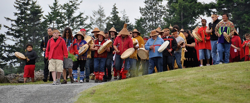 People greeting the canoes at Tulalip Bay