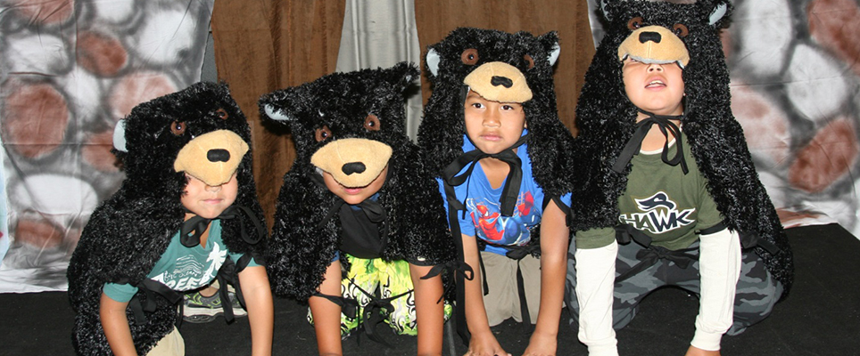 Children performing as black bears in a local production